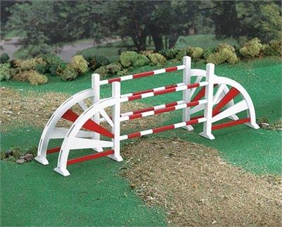 Breyer Horses Show Jumping Oxer Jump - Red and White # 2014 Oxers are a set of fences placed several feet apart that give width to an obstacle, encouraging a greater effort from the horse. This wooden jump is painted in colorful red and white.