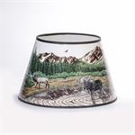 Rustic Mountain Scene with lake, Elk, and Moose  Bring mountain flair to your Aladdin table lamp. This exclusive parchment shade features artwork by renowned local artist Dennis Lipp, perfect for adding a touch of décor to your home. Plus, it helps diffus